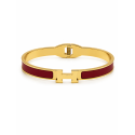 Brazalete rígido de diseño moderno con detalles esmaltados y acabado premium.